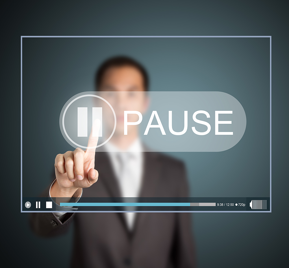 Man pushing a pause button illustration
